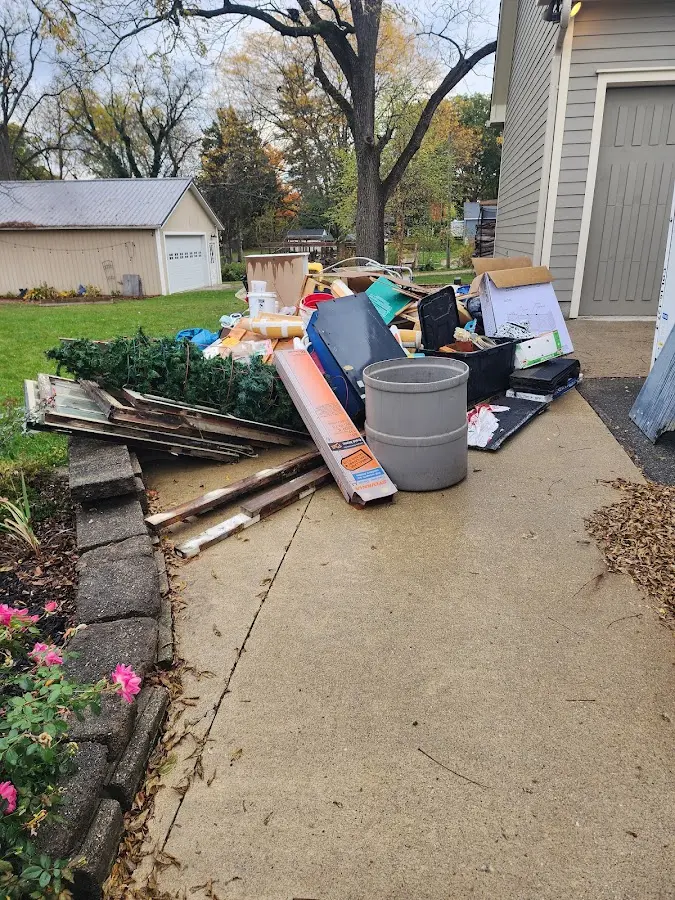 Dumpster being loaded with debris for Estate Cleanout Dumpster Rental in Sellersburg